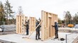 © starush - Carpenters prepare modular timber walls at a Swedish housing site