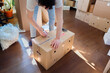 © OchreOchre/Stocksy - Person Labeling Moving Box During Relocation Packing