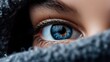 © aji - Close up of a human eye with blue iris and reflection.