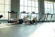 © ultramansk - Young mother and her little daughter in sportswear do synchronized side leg lifts on the mat at their morning exercise session in the gym. Real people enjoying everyday life moments