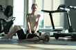 © ultramansk - Fit mom exercising with her cute child do synchronized side leg lifts on the mat during a family workout in a modern sunlit fitness studio, authentic everyday scene