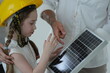 © ultramansk - Young parents teaching their curious child show the child every detail of the small solar panel in the bright interior of their newly built home, authentic everyday scene