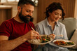 © La Famiglia - Couple enjoying healthy asian food meal at home