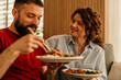 © La Famiglia - Couple eating asian food with chopsticks at home