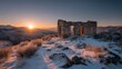 © Zarana  - Stone ruin in snowy landscape at sunset mountainous terrain and golden light