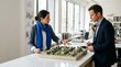 © SashaMagic - Architect and developer collaborate on urban planning model in modern office, discussing future development projects.