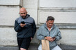 © Nazareno - Men using smartphones connecting with technology outdoors
