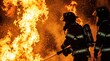 © Tommy Studio - Firefighters in full protective suit and gear standing against intense burning flames and flying sparks.