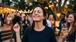 © Pris - Woman enjoying a festive outdoor party with friends and sparkling wine