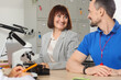 © Pixel-Shot - Portrait of smiling teachers at table in school office