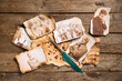 © Pixel-Shot - Old photos of relatives with pen on wooden background. Concept of family tree