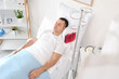 © Pixel-Shot - Male patient transfusing blood on bed in hospital ward
