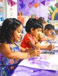 © Raju - Group of diverse children painting with watercolors in an art class.