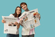 © Pixel-Shot - Young couple with newspapers on blue background