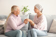 © Pixel-Shot - Young woman after chemotherapy with her mother holding hands at home. Stomach cancer concept