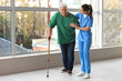 © Pixel-Shot - Nurse helping senior man with stick to walk at hospital
