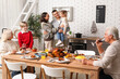 © Pixel-Shot - Happy family having dinner at festive table on Thanksgiving Day