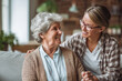 © Choirul - Happy senior woman smiling with young female caregiver or daughter at home