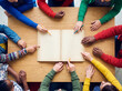 © Aleksandra - Group of children brainstorming around an open book on a table