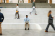 © BusinessClass by W61 - Focused businessman uses laptop on office stairs amidst rush