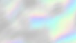 © kastanka - Colorful iridescent, holographic rainbow foil texture, gradient background for prints. Noise textured surface.