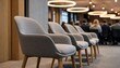 © graphicssajib - Stylish modern chairs arranged in a conference room with people in the background