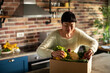 © Davor - Woman unpacking fresh produce delivery box in home kitchen