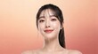 © Muhammad - Beautiful young Asian woman with wet glowing skin, smiling female model with water dripping from chin, studio beauty portrait on peach gradient background