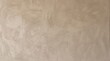 © Azril - Neutral warm beige stucco wall background with grainy texture