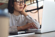© tippapatt - Business person working on laptop and bored in office. Fatigue and tired woman using laptop, browsing the internet. Exhausted employee with depression in workplace
