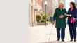 © Nei Mar - Elderly man walking with white cane and smiling with companion outdoors