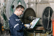 © Quality Stock Arts - Professional Engineer Worker Schedule Inspecting Machine condition for safety in Heavy Industry Machinery Factory