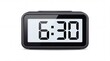 © muawiya - Modern digital alarm clock showing six thirty morning time inside dark plastic frame on white background