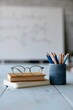 © Iryna - Minimal study arrangement with eyeglasses books and pencil holder for education background and learning wallpaper