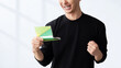 © Trickster* - 通帳を見て喜ぶ男性, Happy Man Looking at a Bankbook