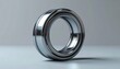 © Isti - Close up of a shiny metallic ball bearing on a surface.