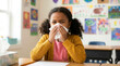 © Iryna - African American schoolgirl sneezing into tissue at desk in classroom, seasonal allergies and childhood illness