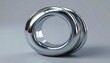 © Anomali - Shiny metallic torus ring with reflective surface.