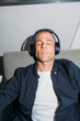 © Maryanne Gobble/Stocksy - Listening to Music Closed Eyes in Airport