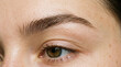 © Hanafi - Close up of a woman's natural eyebrow and eye, showing skin texture and lashes.