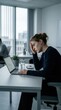 © Ulil - Overworked Young Woman Experiencing Stress While Working Late In Modern Office Environment