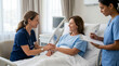 © Mael - Caring nurse comforts patient in hospital bed, another nurse takes notes
