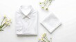 © Isadora - Folded white shirt with napkin and daisy flowers