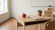 © Jun Kiky - School Desk with Notebook, Pencil, and Red Apple in Bright Classroom