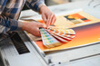 © Serhii - Hand holding color swatch book at printing house