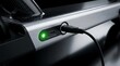 © Aurelia - Close-up of electric vehicle charging port with green light.