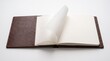 © Azha - Open luxury leather notebook mock up with blank paper page turn on white surface