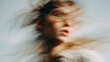 © vannet - Female face disappears into soft motion blur during a quiet moment in daylight as hair flows across her skin to create a minimalist scene of movement and grace