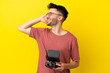 © luismolinero - Man holding a drone remote control isolated on yellow background smiling a lot