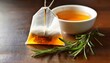 © Samantha - natural herbal tea bag with golden honey and fresh rosemary sprig for healthy lifestyle beverage photography